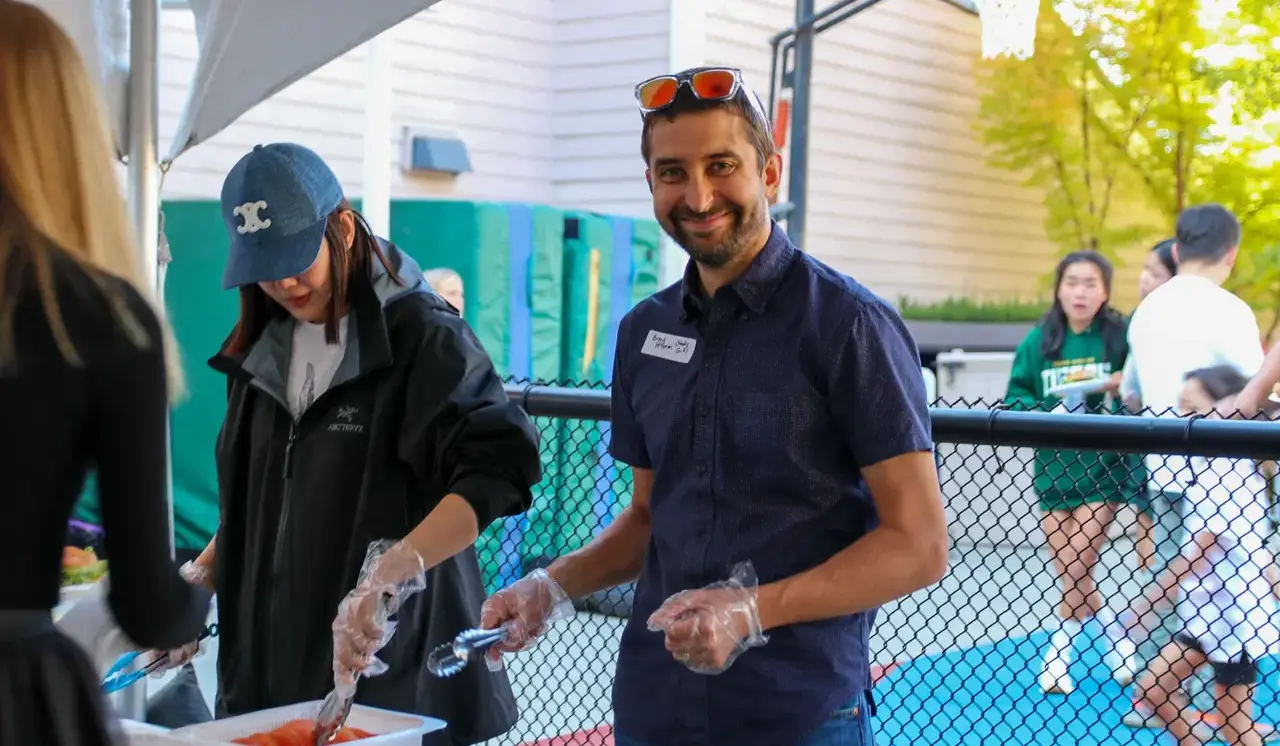 A Parent helping out with BBQ