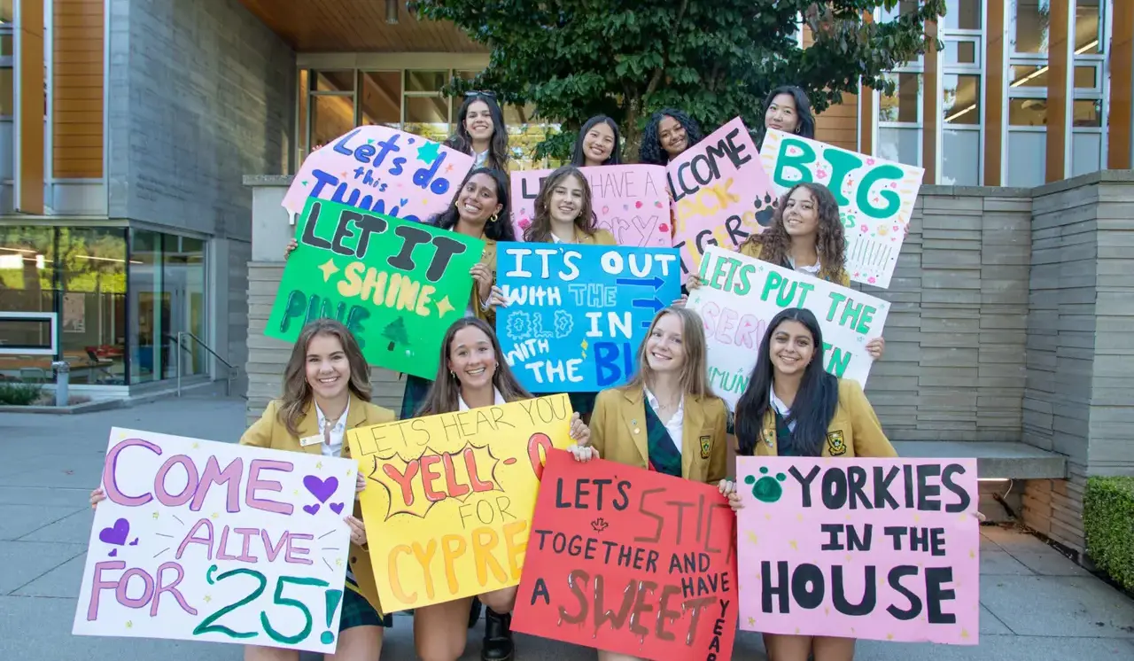 Students holding back to school sign