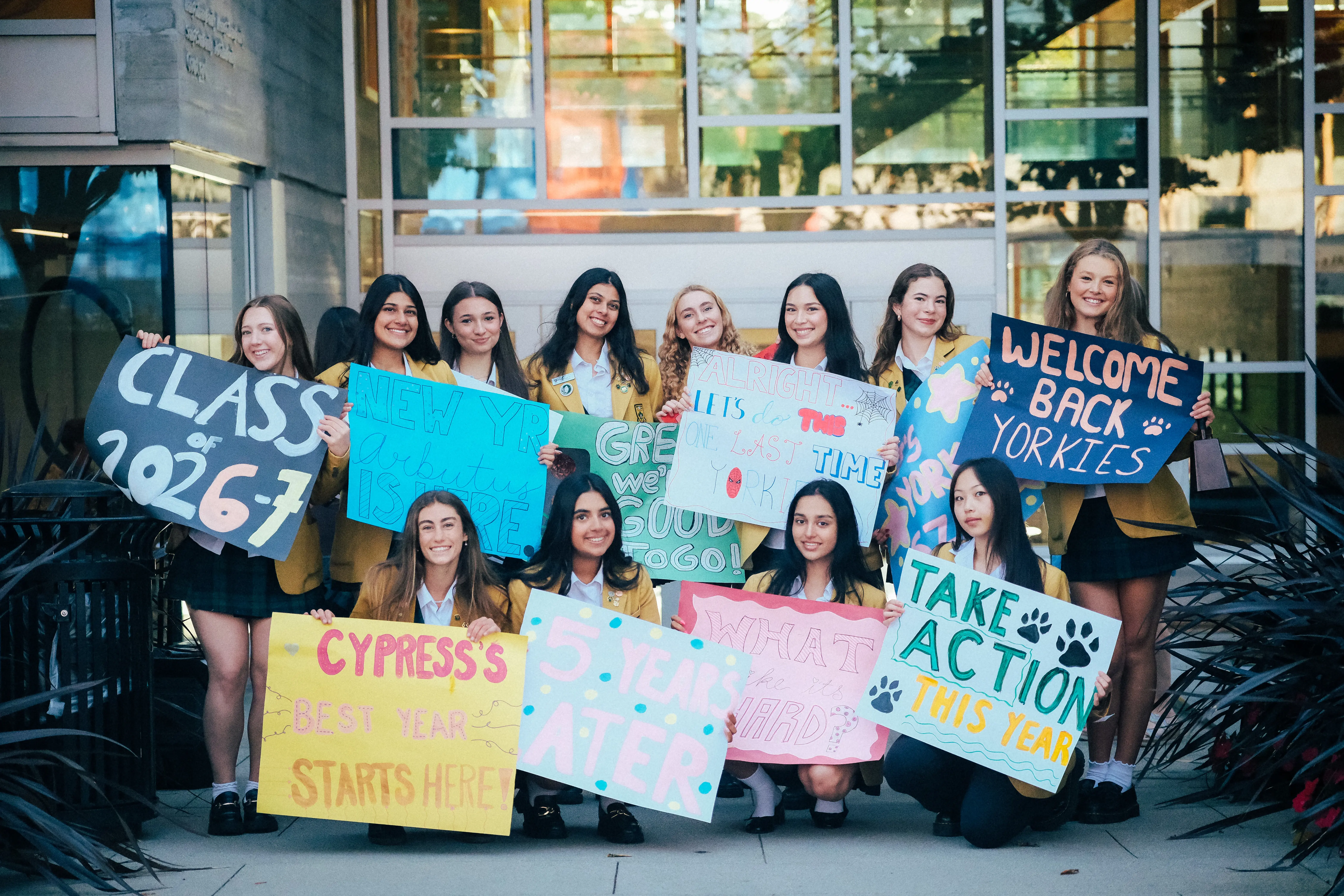 A Group of Senior School Student Leaders holding welcome signs at school entrance