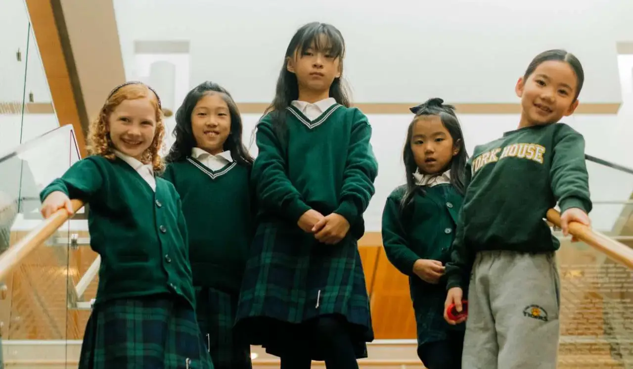 Junior students standing on stairs