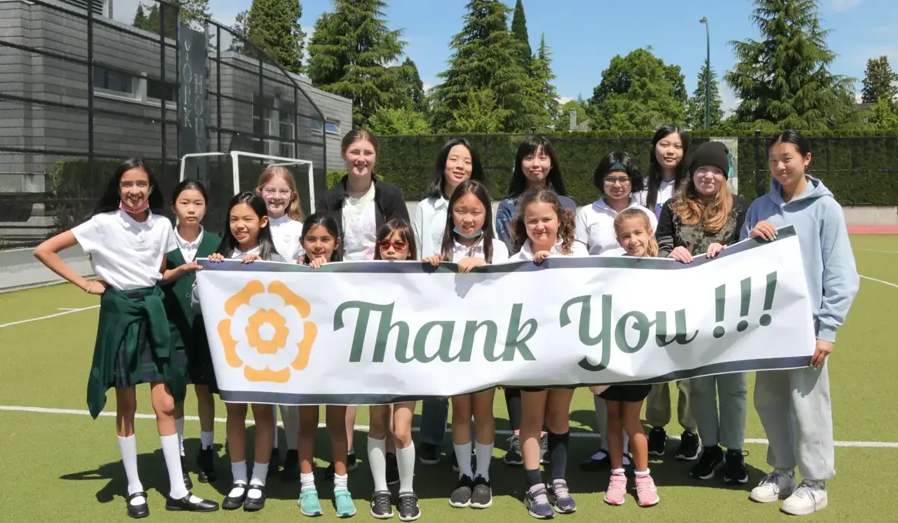 Students holding thank you Banner